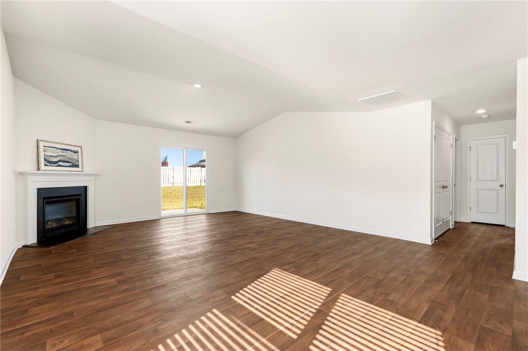 205 Hillendale Way Pelzer, SC 29669 - Photo 4 of 29 This expansive great room offers wood flooring, a charming fireplace, and abundant natural light.