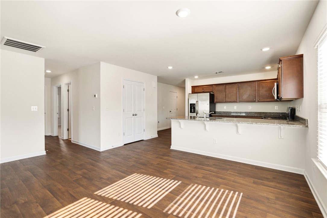 205 Hillendale Way Pelzer, SC 29669 - Photo 8 of 29 This inviting space combines a functional kitchen with an open living area, ideal for daily life.