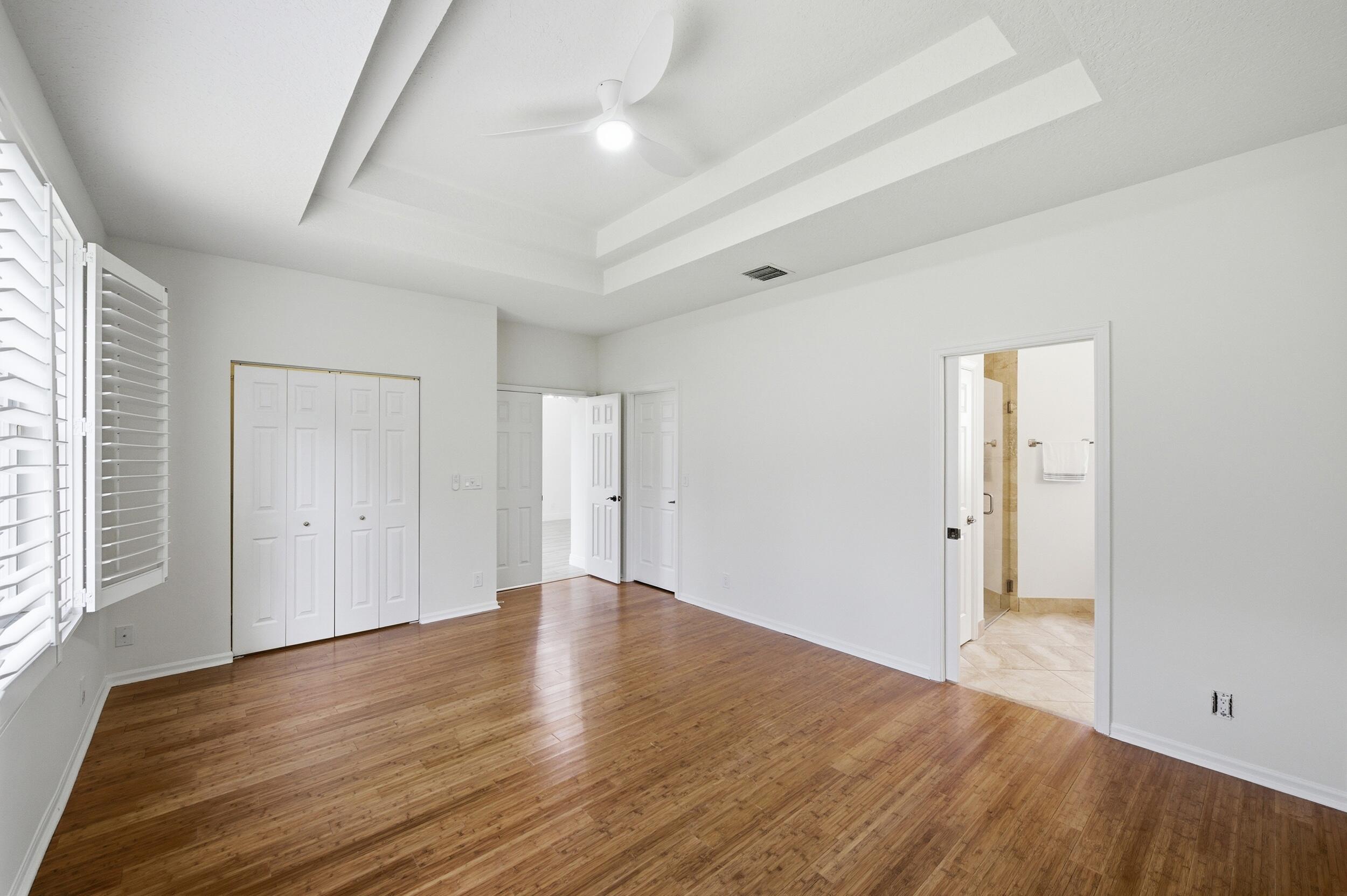 8534 Vía D Oro Boca Raton, FL 33433 - Photo 22 of 34 an empty room with wooden floor and windows