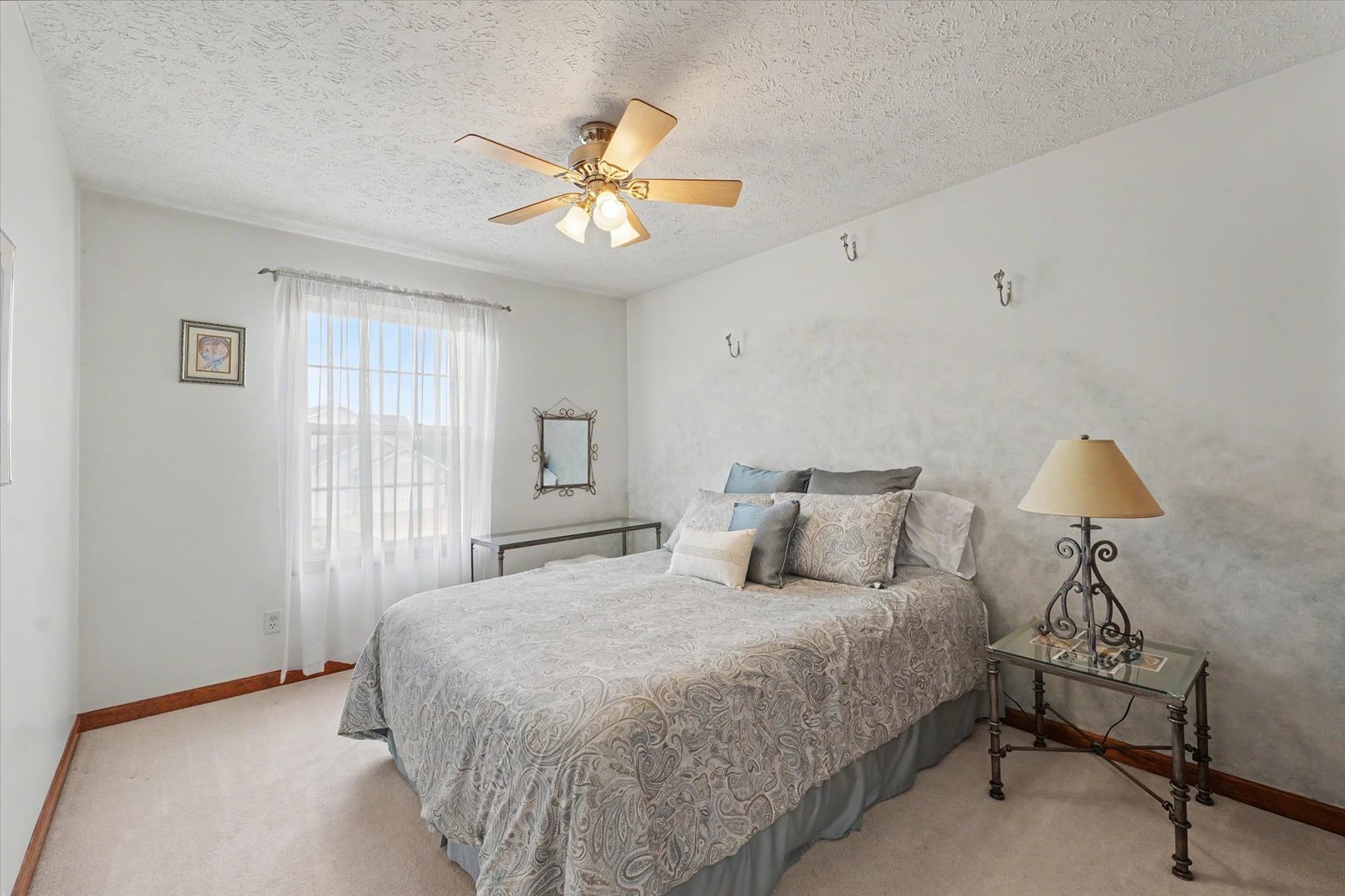 4409 Copper Ridge Road Champaign, IL 61822 - Photo 27 of 40 a bedroom with a bed and a chandelier