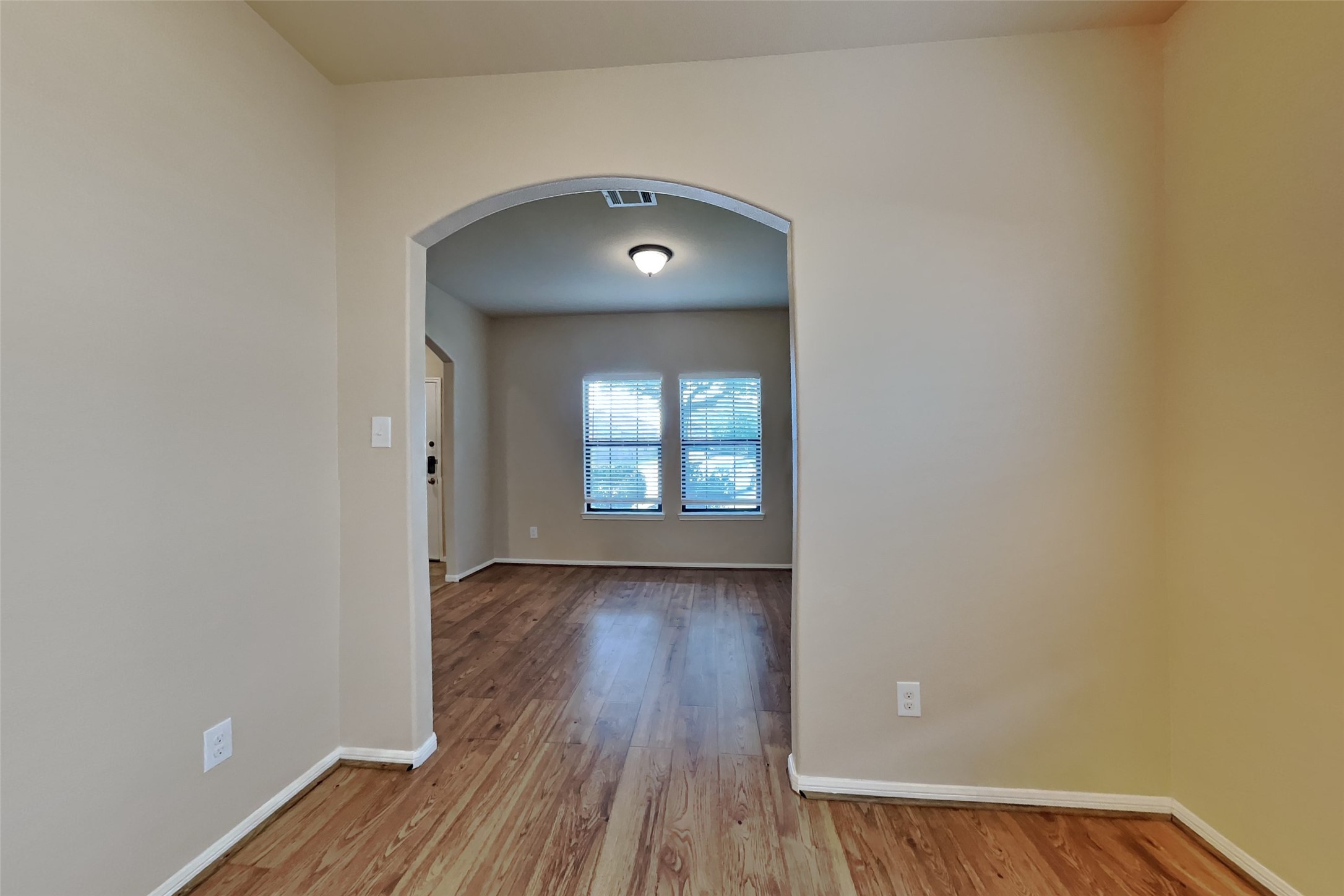 19715 Seabury Path Ct. Katy, TX 77449 - Photo 7 of 20 a view of an empty room with wooden floor and a window