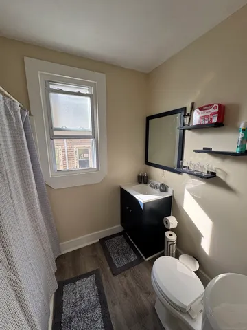 a bathroom with a toilet sink and mirror