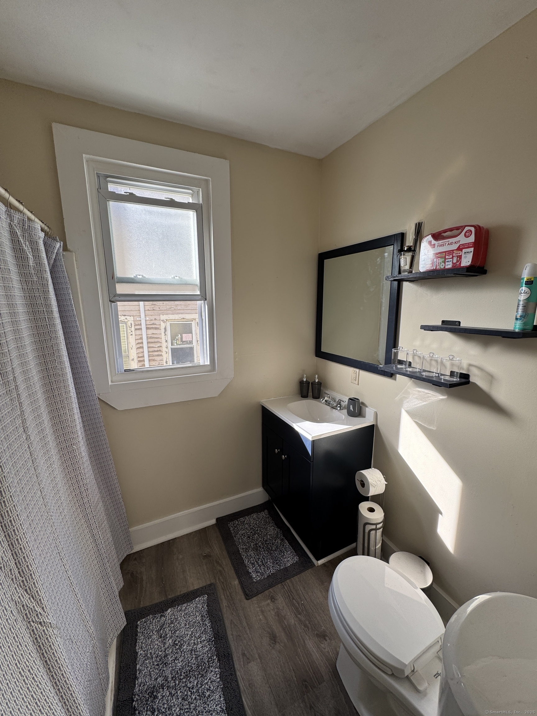 766 George Street, Unit 2 New Haven, CT 06511 - Photo 11 of 20 a bathroom with a toilet sink and mirror
