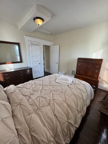 a bedroom with a bed and window