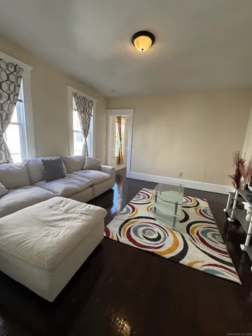 a view of a livingroom with furniture and a window