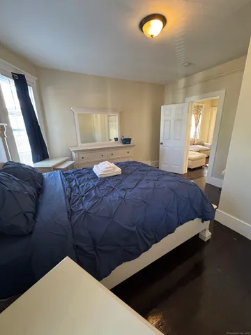 a bedroom with a bed and window