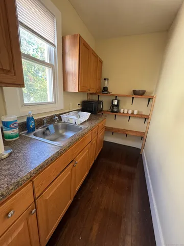 a kitchen with sink cabinets and window