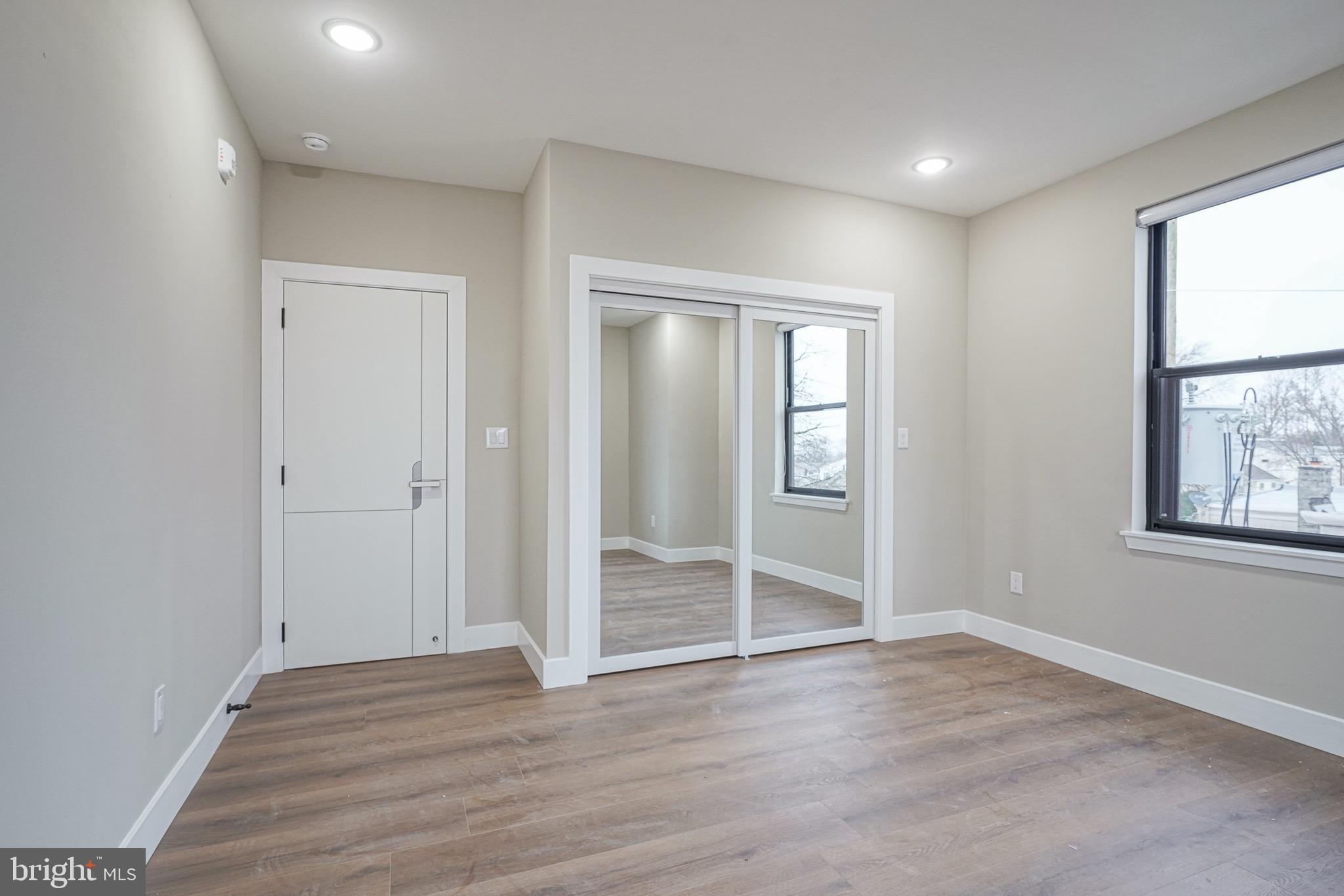 4432-00 Wingate Street, Unit 202 Philadelphia, PA 19136 - Photo 17 of 32 an empty room with wooden floor and windows