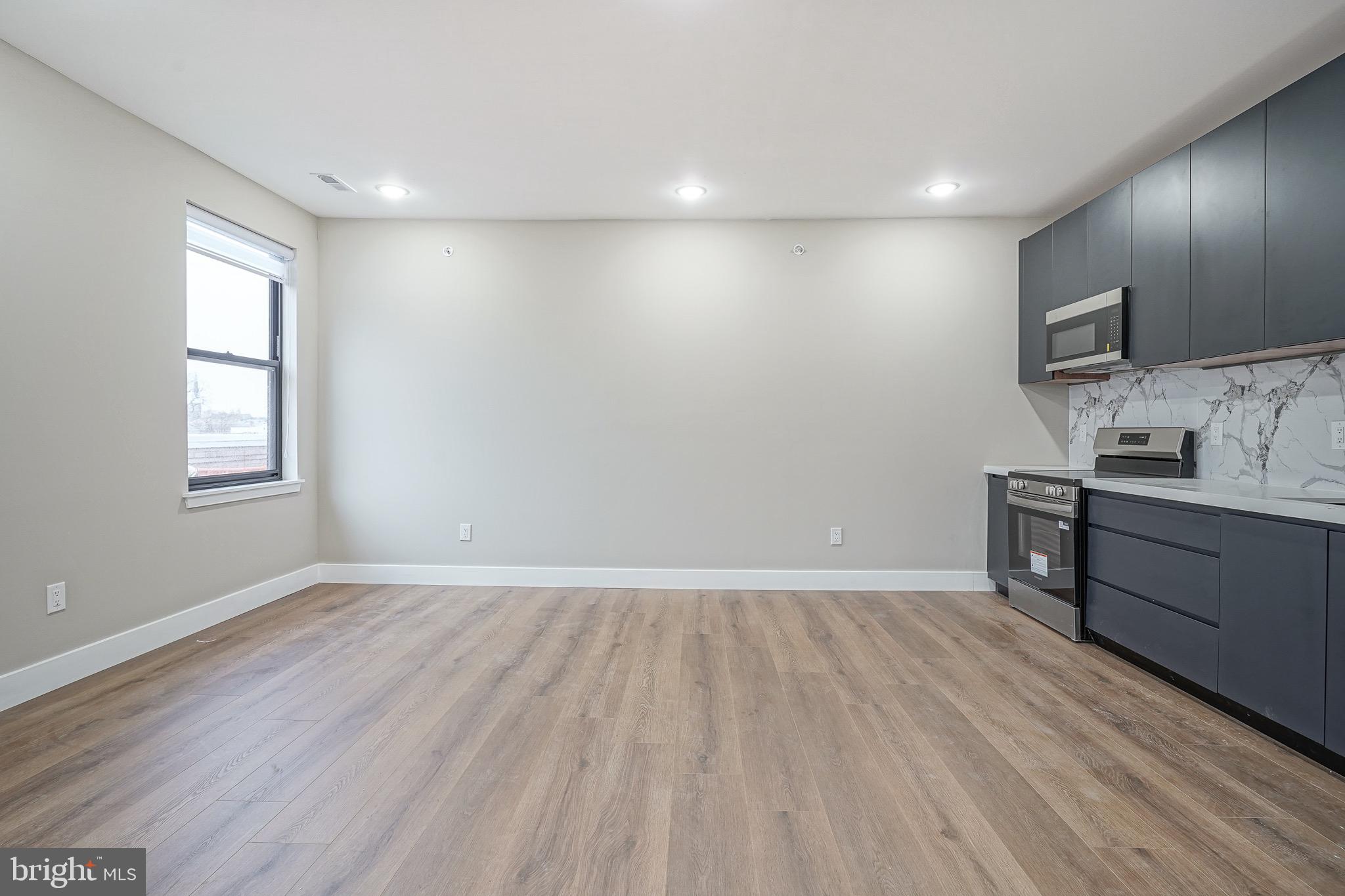 4432-00 Wingate Street, Unit 202 Philadelphia, PA 19136 - Photo 18 of 32 a view of a room with wooden floor and window