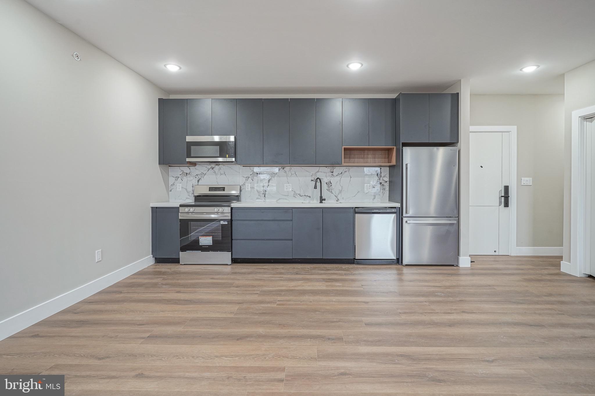 4432-00 Wingate Street, Unit 202 Philadelphia, PA 19136 - Photo 19 of 32 a kitchen with stainless steel appliances a refrigerator and a oven
