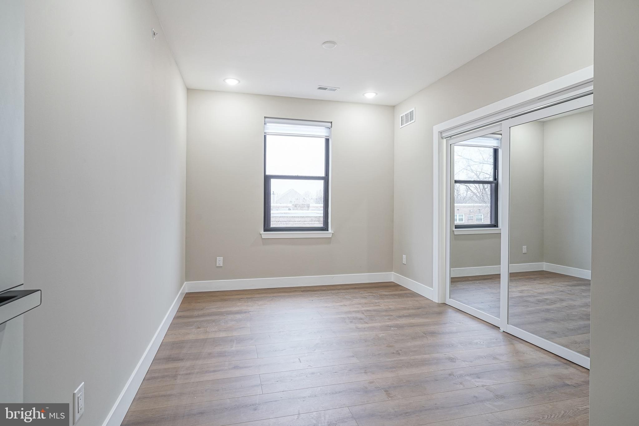 4432-00 Wingate Street, Unit 202 Philadelphia, PA 19136 - Photo 23 of 32 an empty room with wooden floor and windows