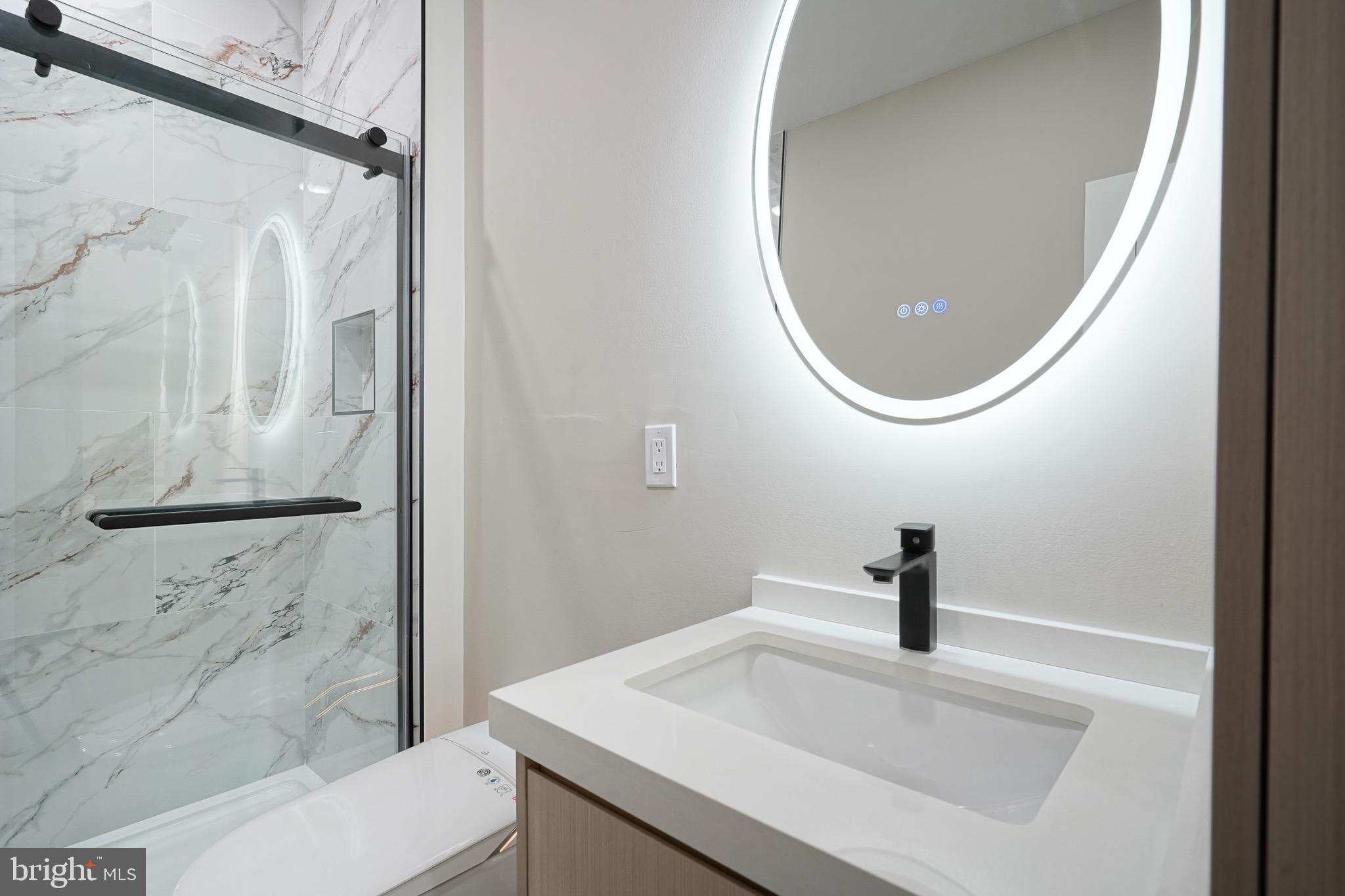 4432-00 Wingate Street, Unit 202 Philadelphia, PA 19136 - Photo 29 of 32 a bathroom with a sink and a mirror