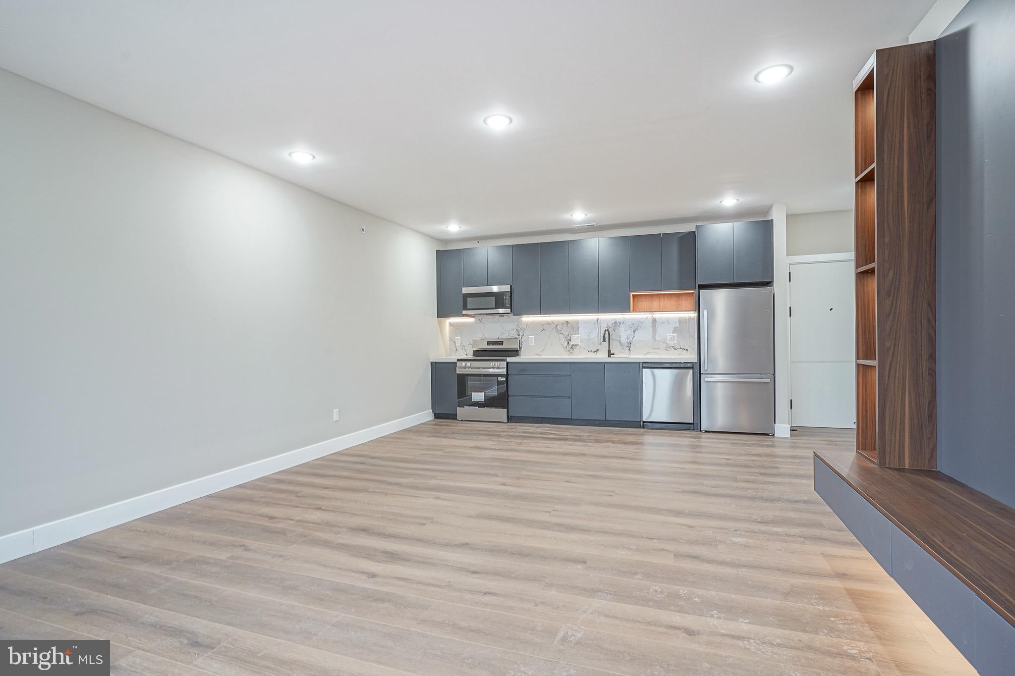 4432-00 Wingate Street, Unit 202 Philadelphia, PA 19136 - Photo 8 of 32 a view of kitchen with kitchen island a sink appliances and cabinets