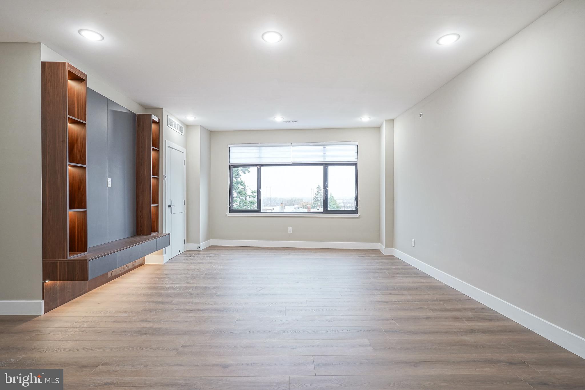 4432-00 Wingate Street, Unit 202 Philadelphia, PA 19136 - Photo 9 of 32 an empty room with wooden floor and windows