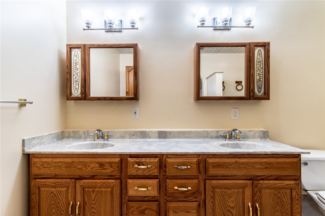 5802 Limerick Drive Corpus Christi, TX 78413 - Photo 19 of 34 a bathroom with a sink vanity and mirror