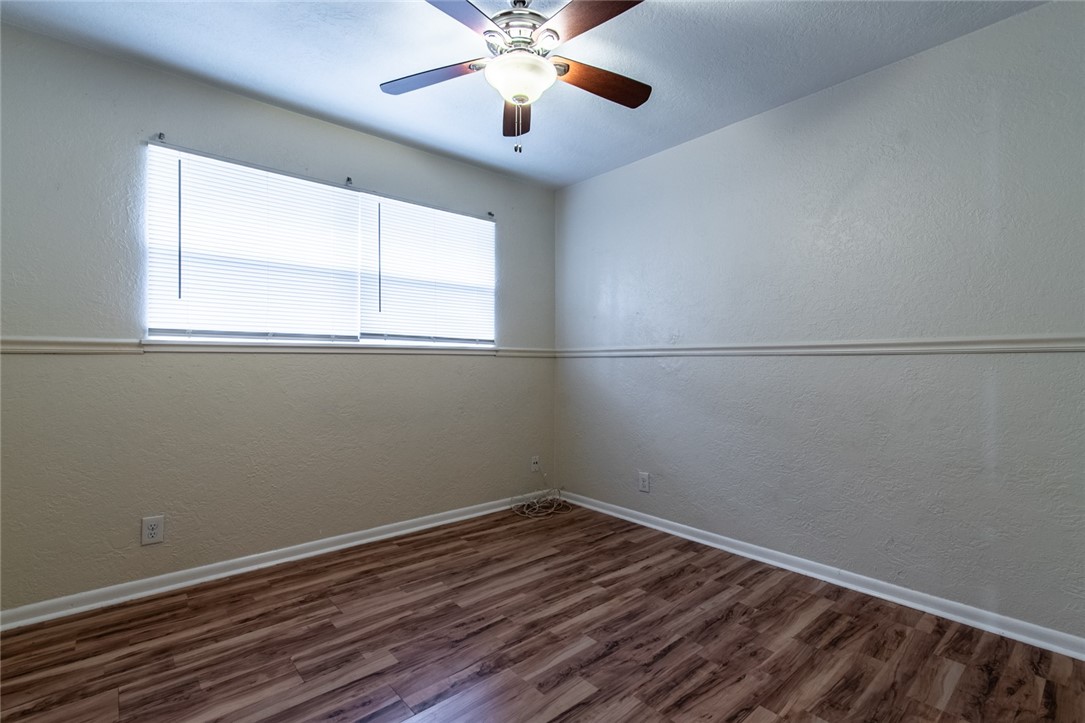 5802 Limerick Drive Corpus Christi, TX 78413 - Photo 25 of 34 an empty room with a window and a fan
