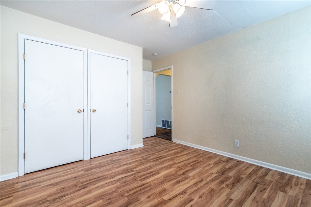 5802 Limerick Drive Corpus Christi, TX 78413 - Photo 29 of 34 a view of a room with wooden floor and a ceiling fan