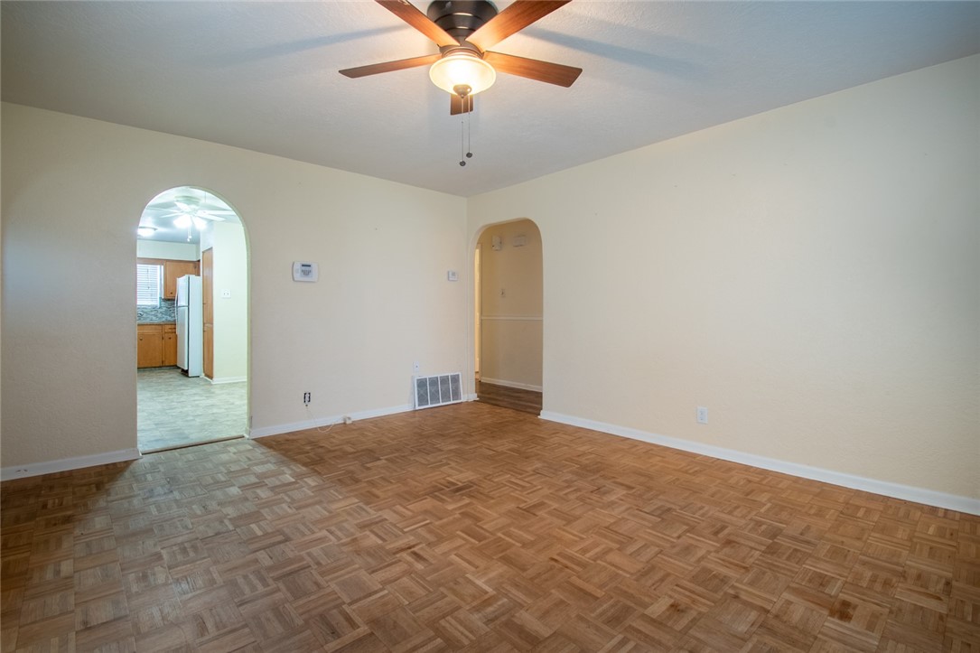 5802 Limerick Drive Corpus Christi, TX 78413 - Photo 6 of 34 an empty room with a chandelier fan and windows