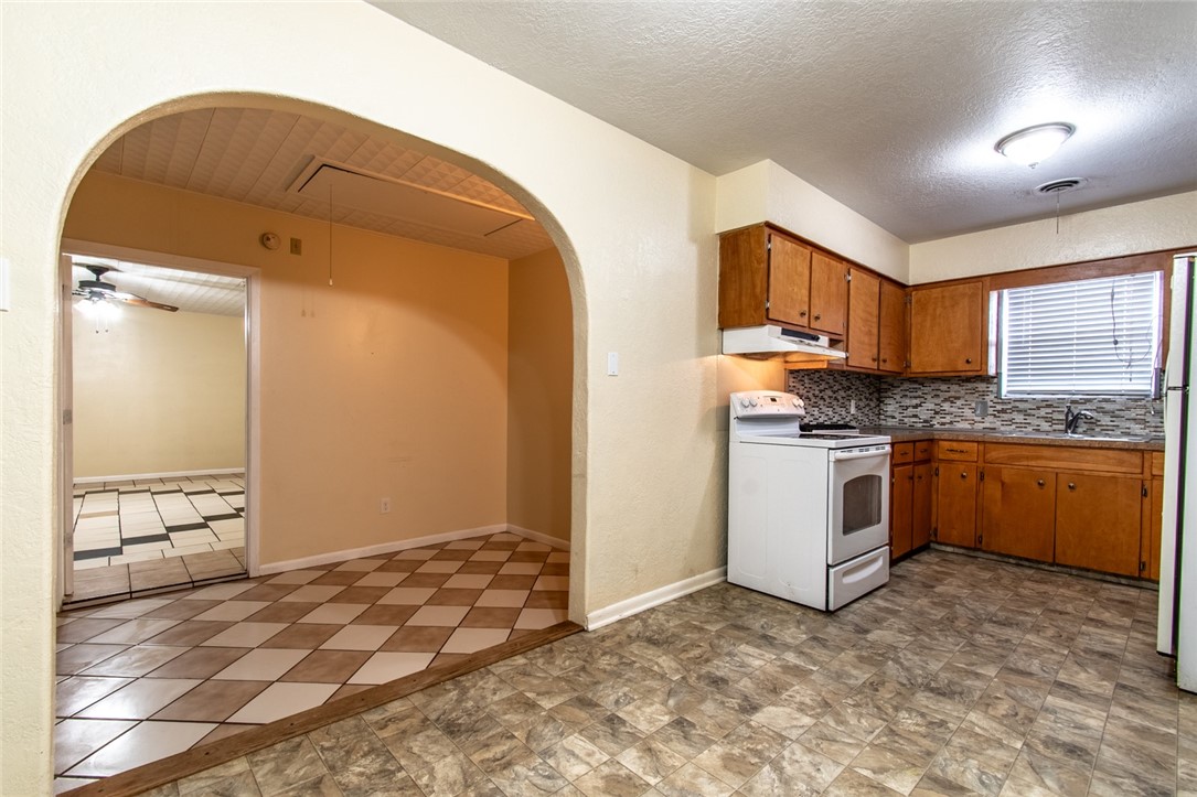 5802 Limerick Drive Corpus Christi, TX 78413 - Photo 10 of 34 a kitchen with granite countertop a stove a sink and a refrigerator