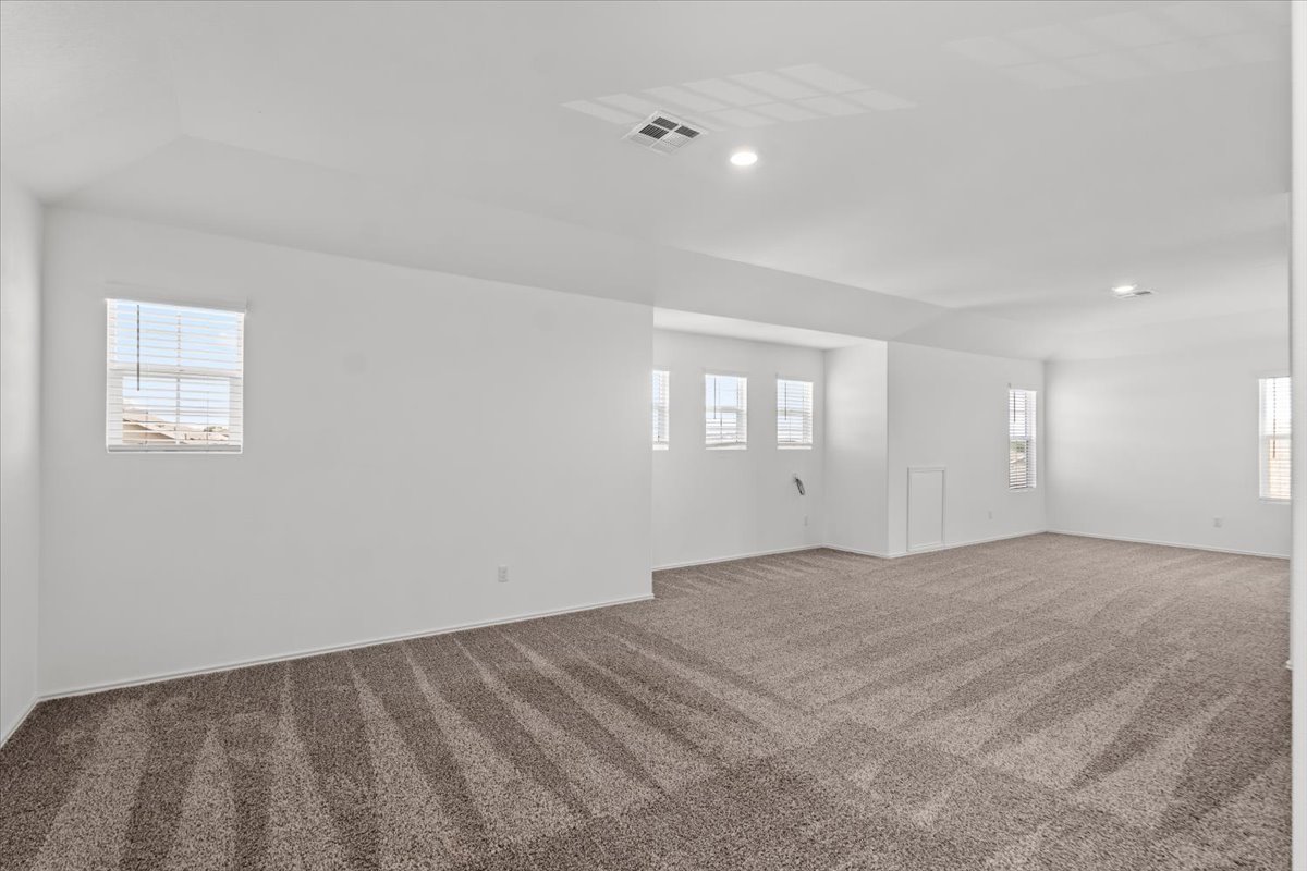 448 Perfect World Loop Jarrell, TX 76537 - Photo 32 of 40 A spacious, naturally illuminated room featuring plush carpeting and multiple windows.