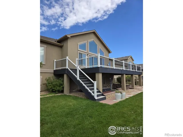 a view of a house with a big yard and a large tree