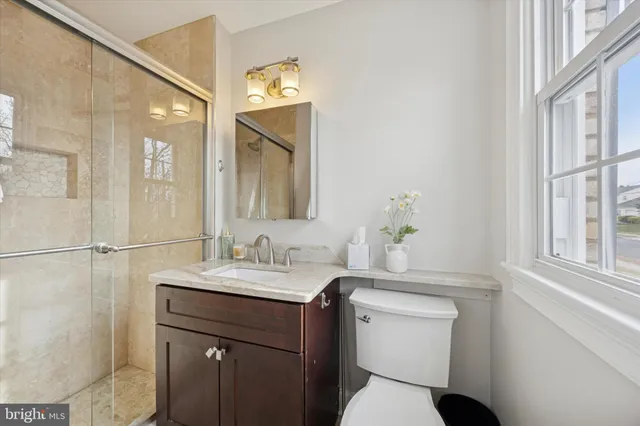 a bathroom with a sink toilet and a mirror