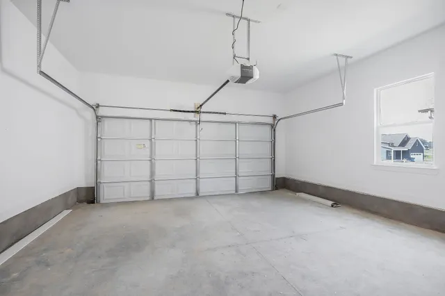 an empty room with a window and a ceiling fan