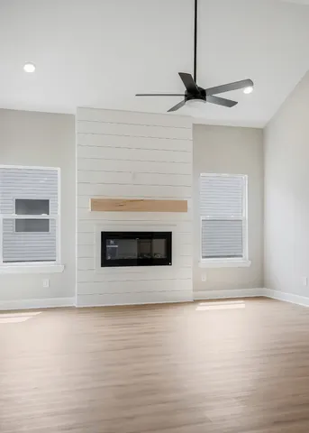 a kitchen with stainless steel appliances granite countertop a stove top oven a sink a refrigerator and white cabinets