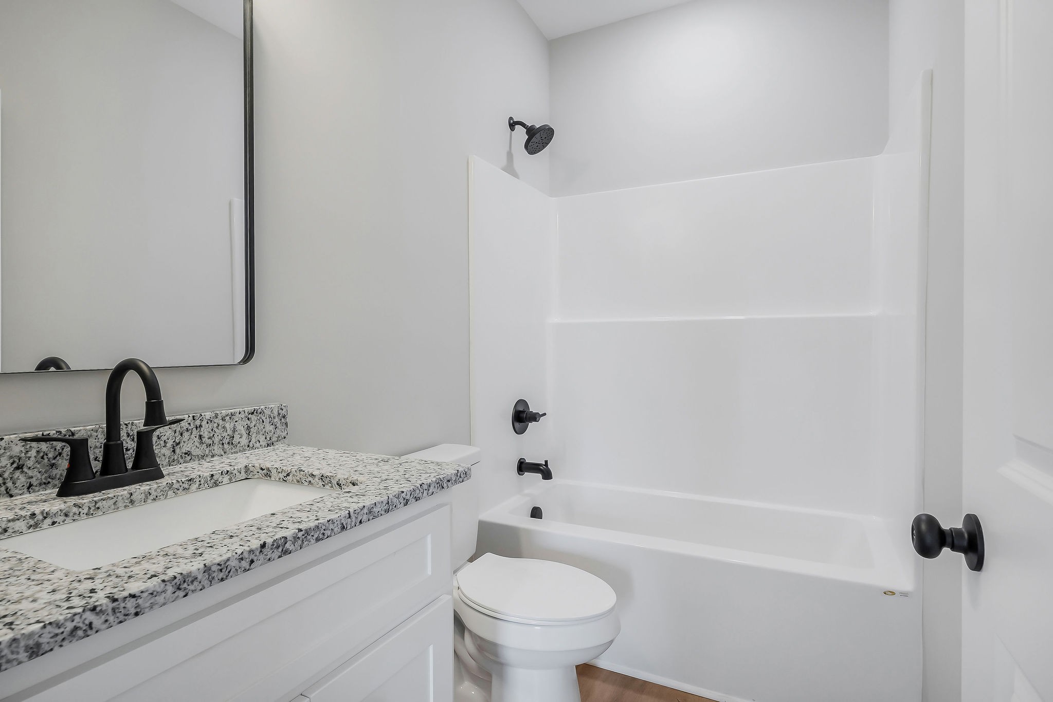 117 Reece Road Baxter, TN 38544 - Photo 24 of 31 a bathroom with a granite countertop sink a toilet and a bathtub