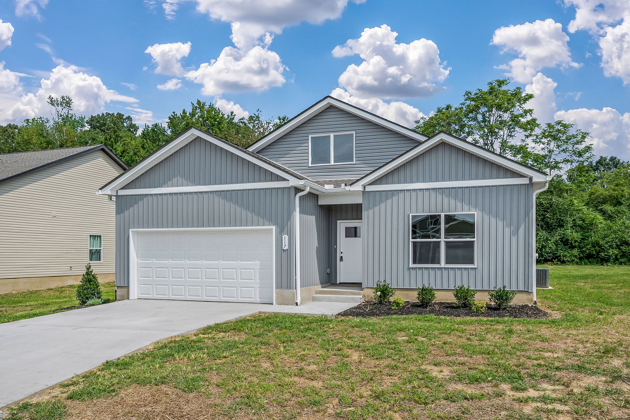 117 Reece Road Baxter, TN 38544 - Photo 30 of 31 a front view of a house with a yard and garage