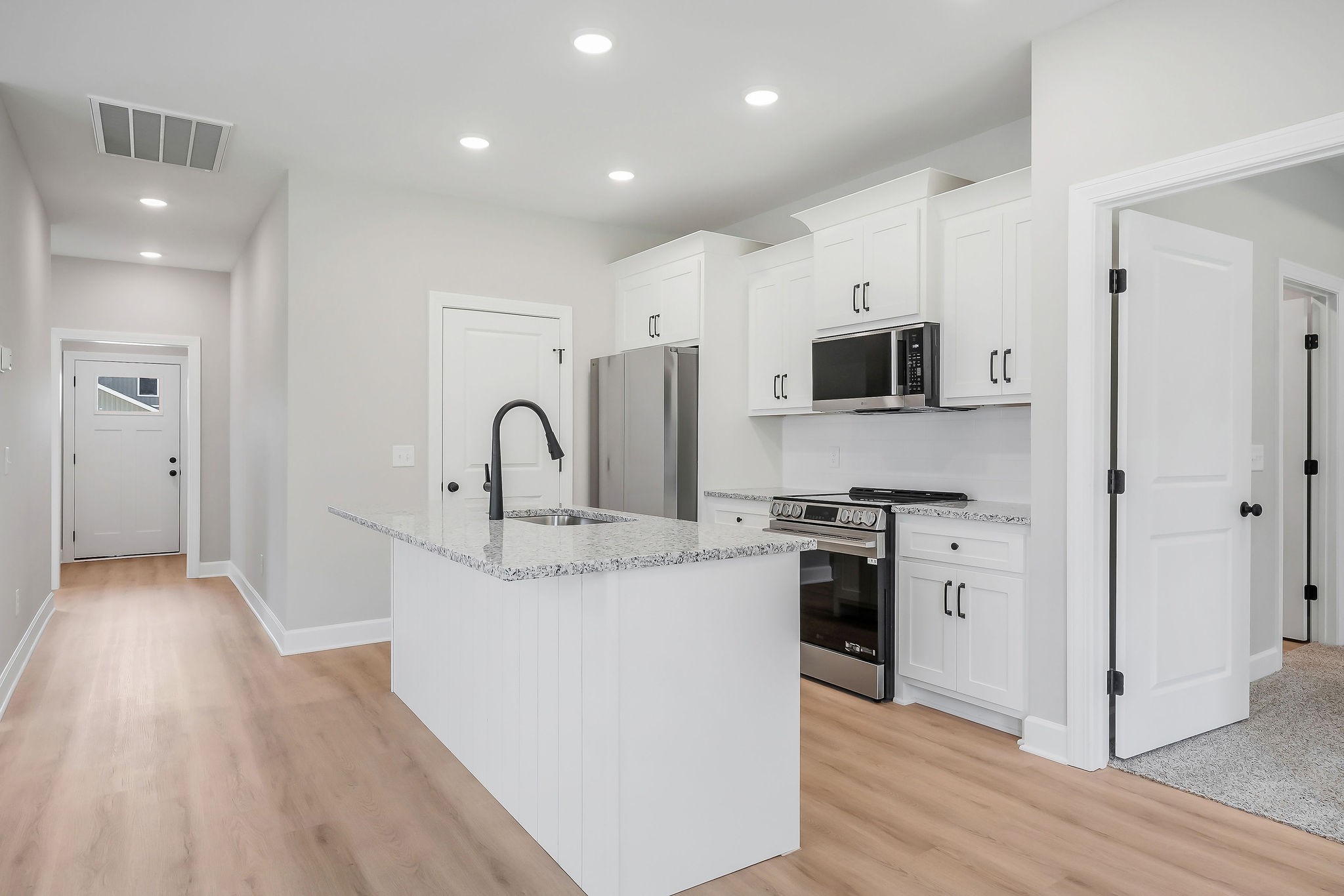 117 Reece Road Baxter, TN 38544 - Photo 8 of 31 a kitchen with stainless steel appliances granite countertop a stove top oven a refrigerator a sink and a oven with wooden floors