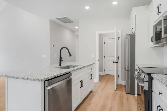 a kitchen with a sink and a refrigerator