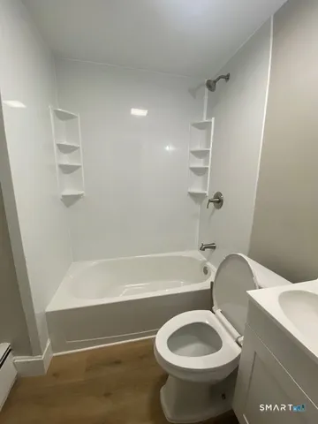 a bathroom with a toilet and a bathtub