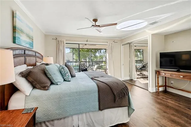 a bedroom with a large bed and a flat screen tv