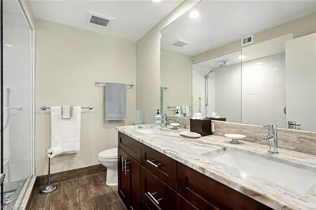 a bathroom with a sink double vanity and a toilet