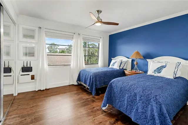 a bedroom with two beds and a window