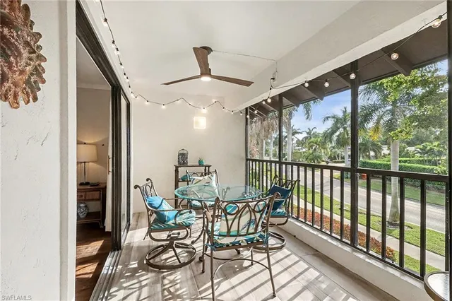 a view of a porch with chairs and backyard