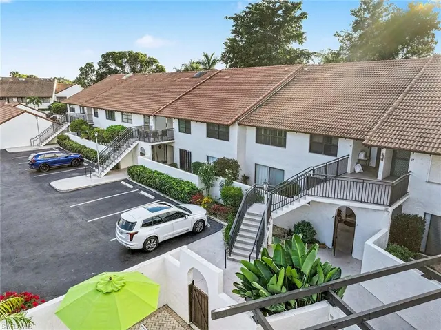 an aerial view of a house with garden space and street view