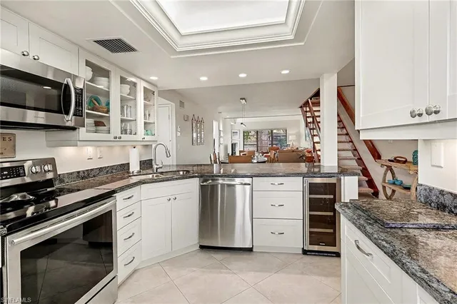 a kitchen with stainless steel appliances granite countertop a stove and a sink