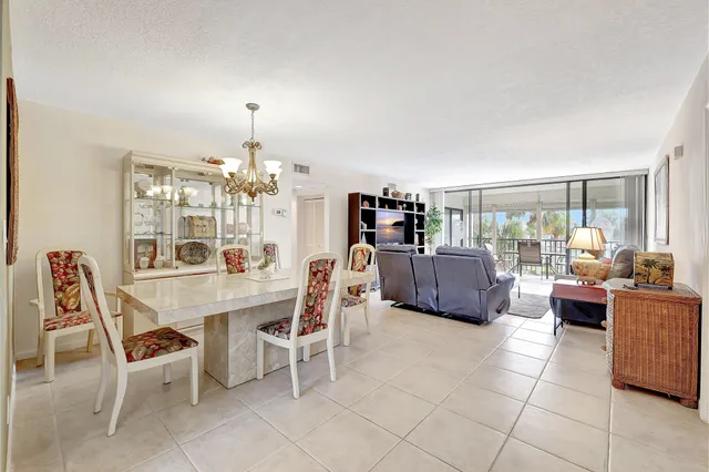 a view of a dining room with furniture and a window