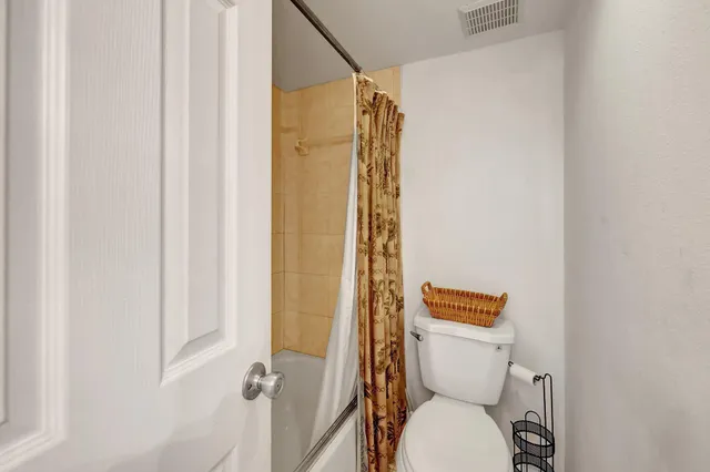 a view of a patio with a table and chairs under an umbrella