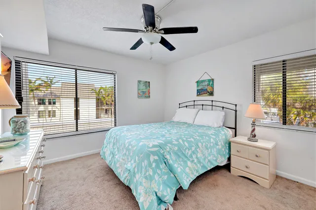 a front view of a house with a yard and lake view