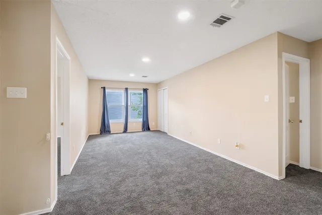 a view of a big room with closet and windows