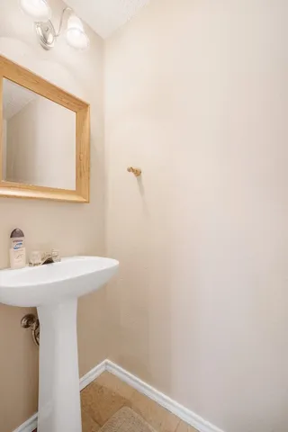 a bathroom with a sink a vanity and a mirror