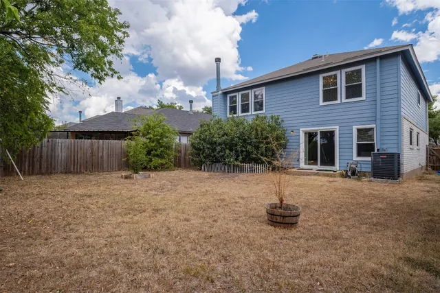 a backyard of a house with yard and outdoor seating