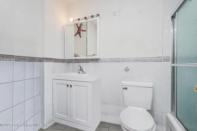 a bathroom with a toilet a sink and shower