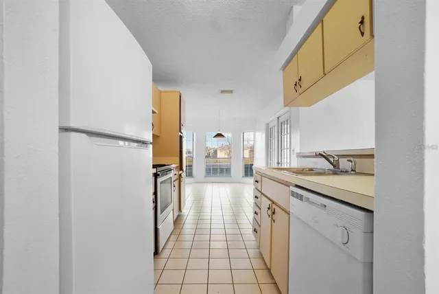 a kitchen with a sink and refrigerator