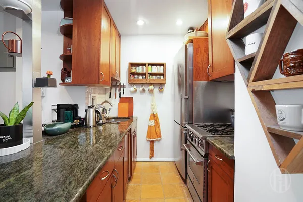a view of kitchen with stainless steel appliances granite countertop sink stove and refrigerator