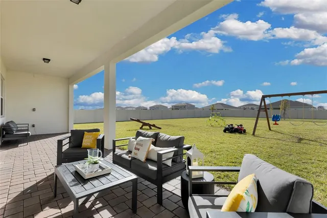a living room with furniture and a floor to ceiling window