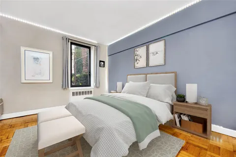 a bedroom with a bed a couch and a window